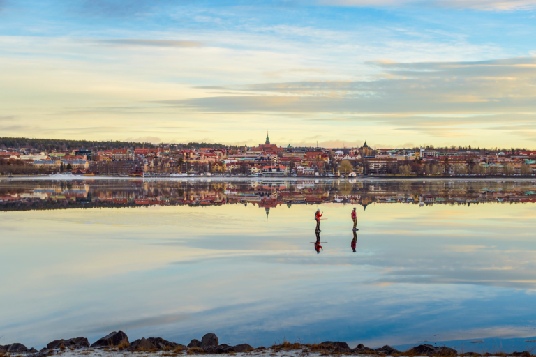 Two people skating on frozen Lake Storsjön, in the city of Östersund, Jämtland Härjedalen, Sweden