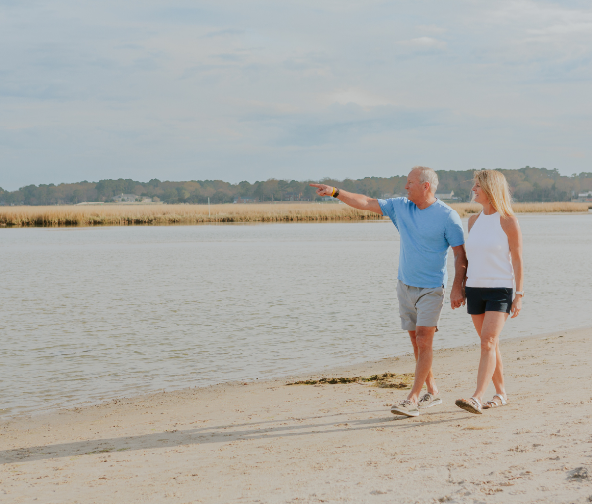 A couple walking in Chesapeake Bay, Virginia Beach, USA.