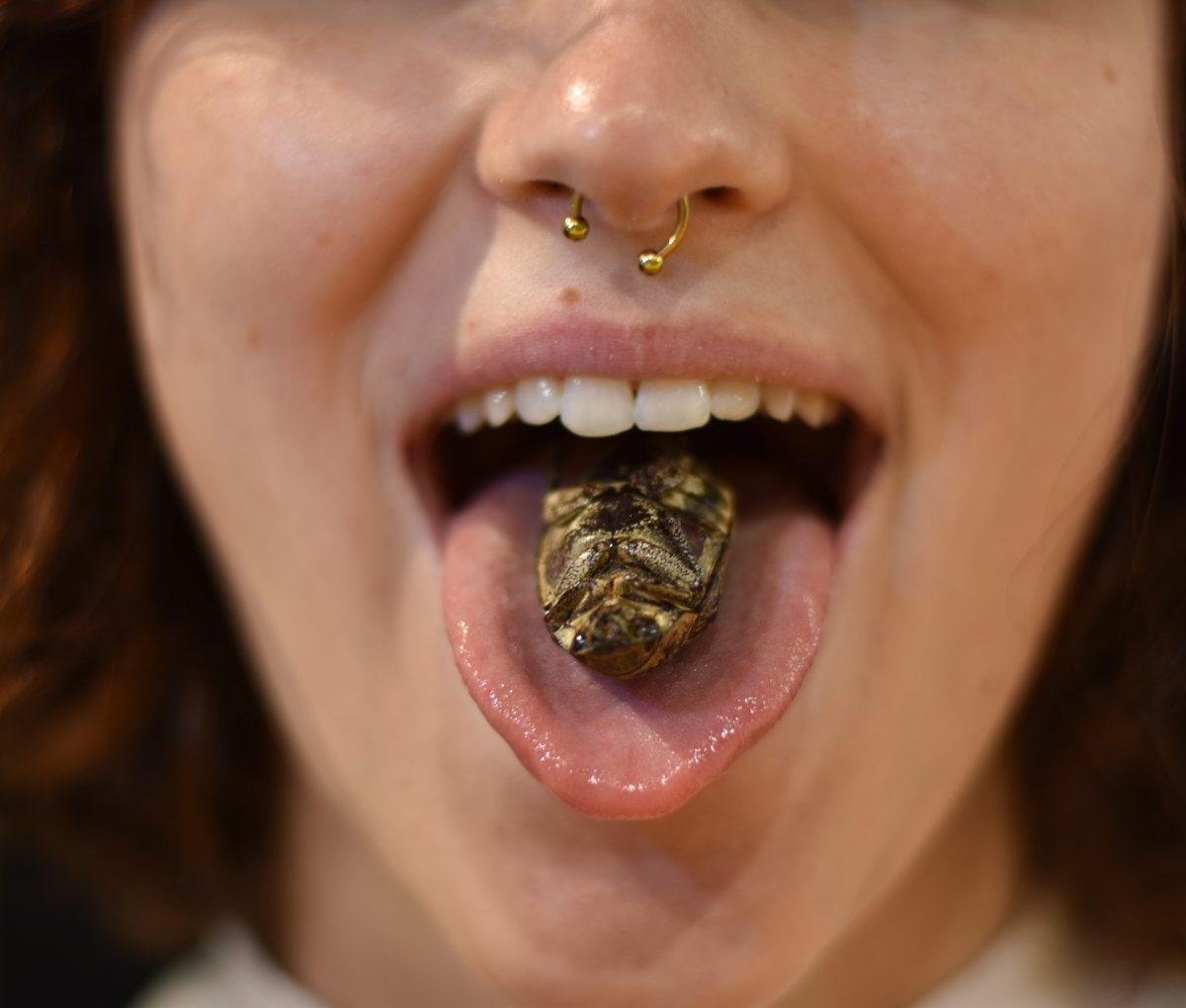 Girl with disgusting food on her tongue at the Disgusting Food Museum in Malmö, Sweden