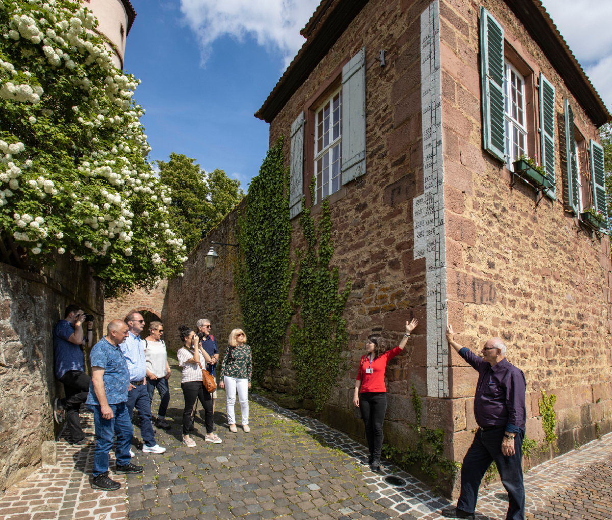 A crowd looking at flood marks in Wertheim, Germany