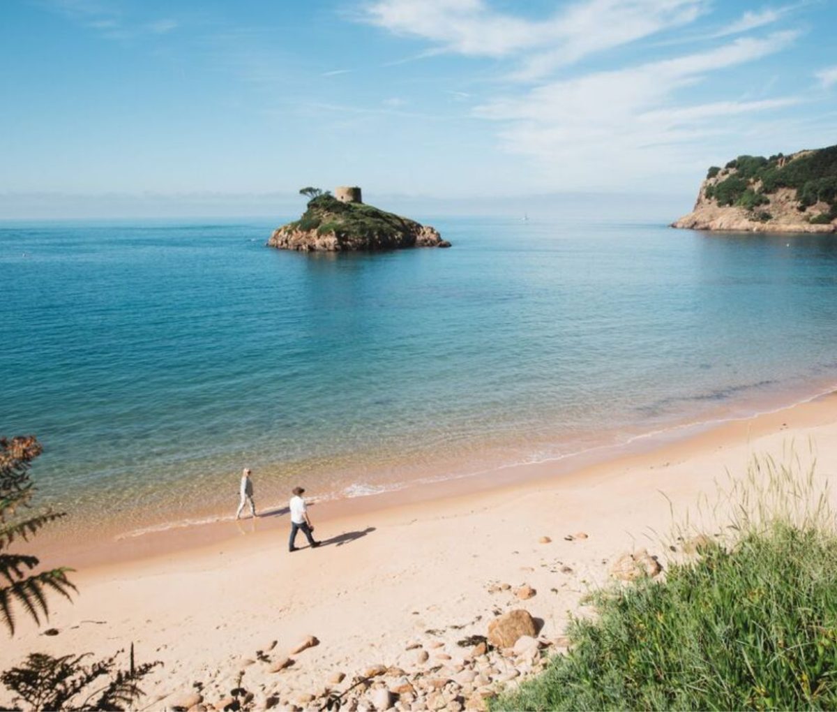 Couple walking in St. Ouens Bay, Jersey