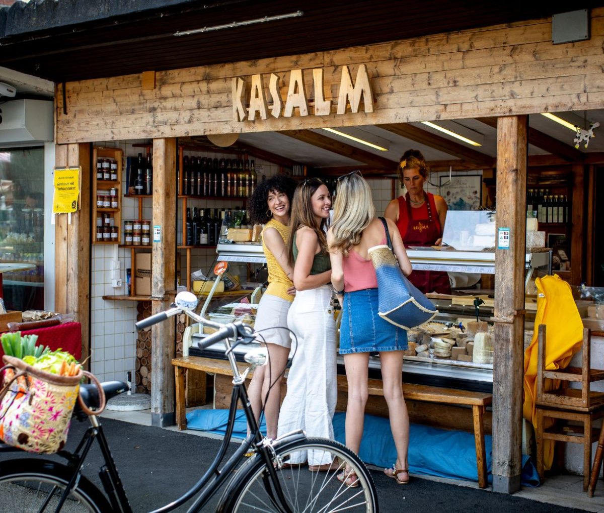 Girls buying food at Kaiser-Josef-Platz Market, Graz, Austria