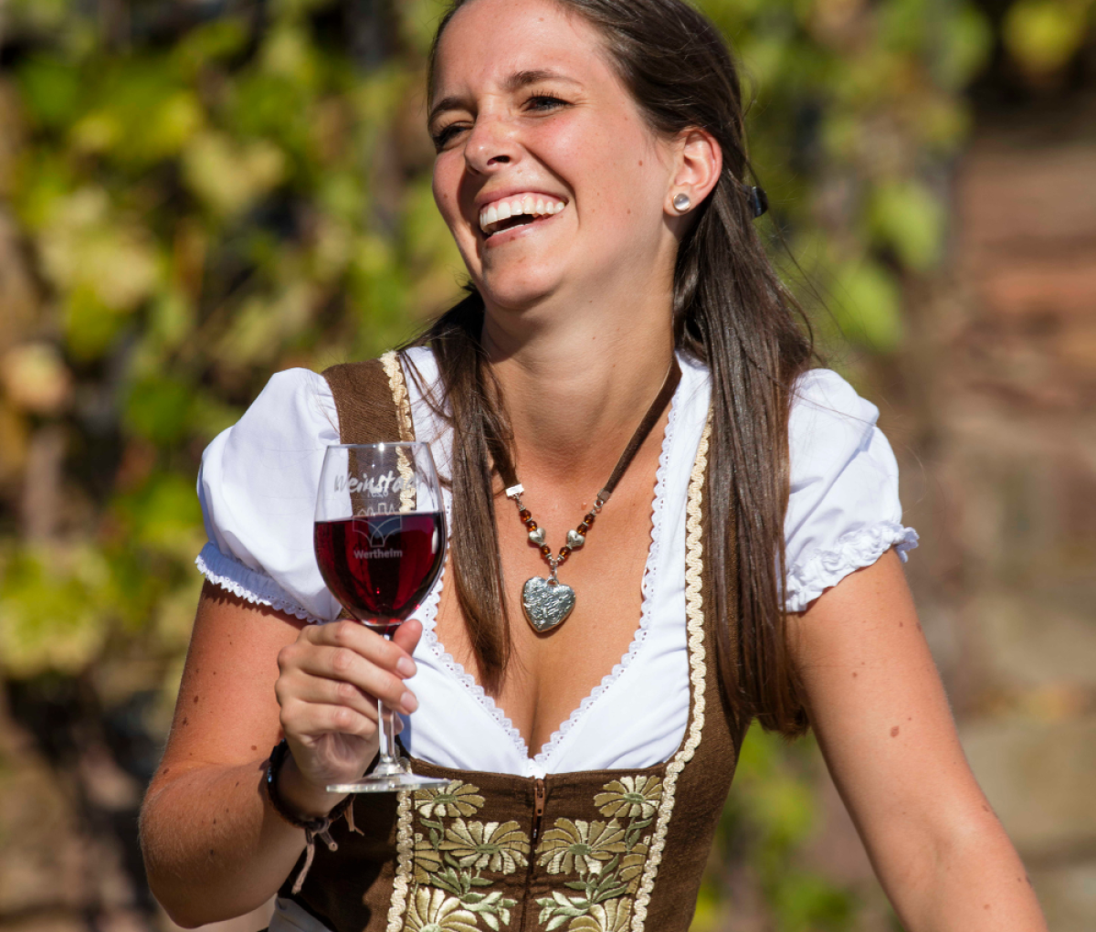 Woman enjoying wine in Wertheim, Germany